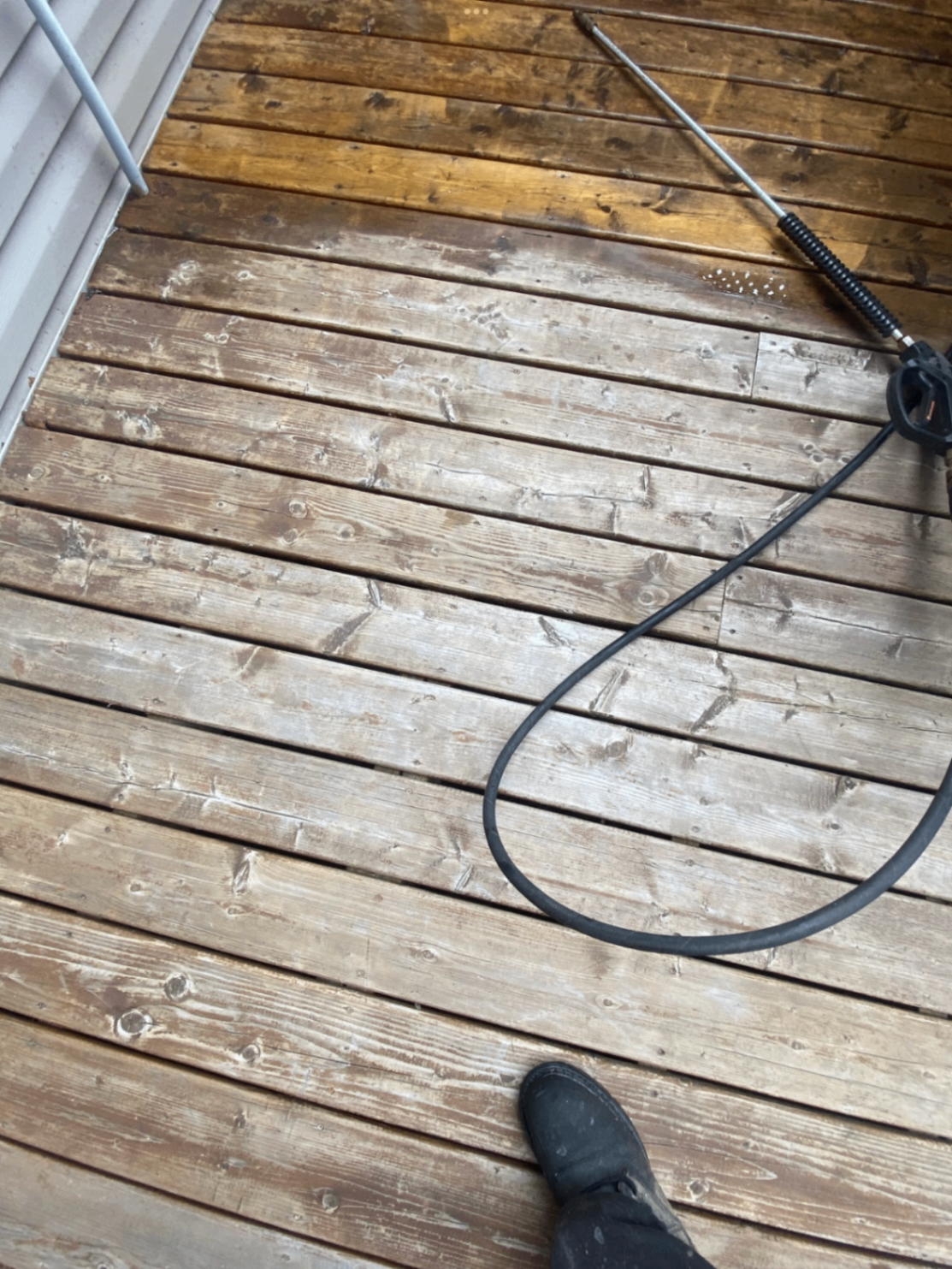 Close view of weathered deck boards before cleaning