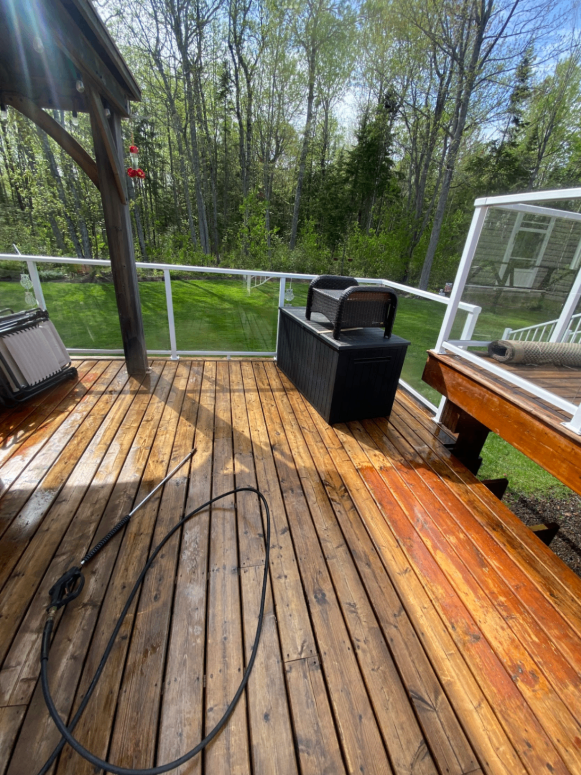 Large wood deck during a pressure washing job with fresh clean boards showing